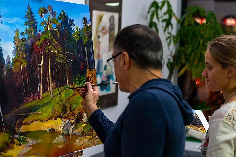 Adults painting at easels in a contemporary art class, demonstrating the range of adult art education options available today, from community college courses to independent studios to online classes