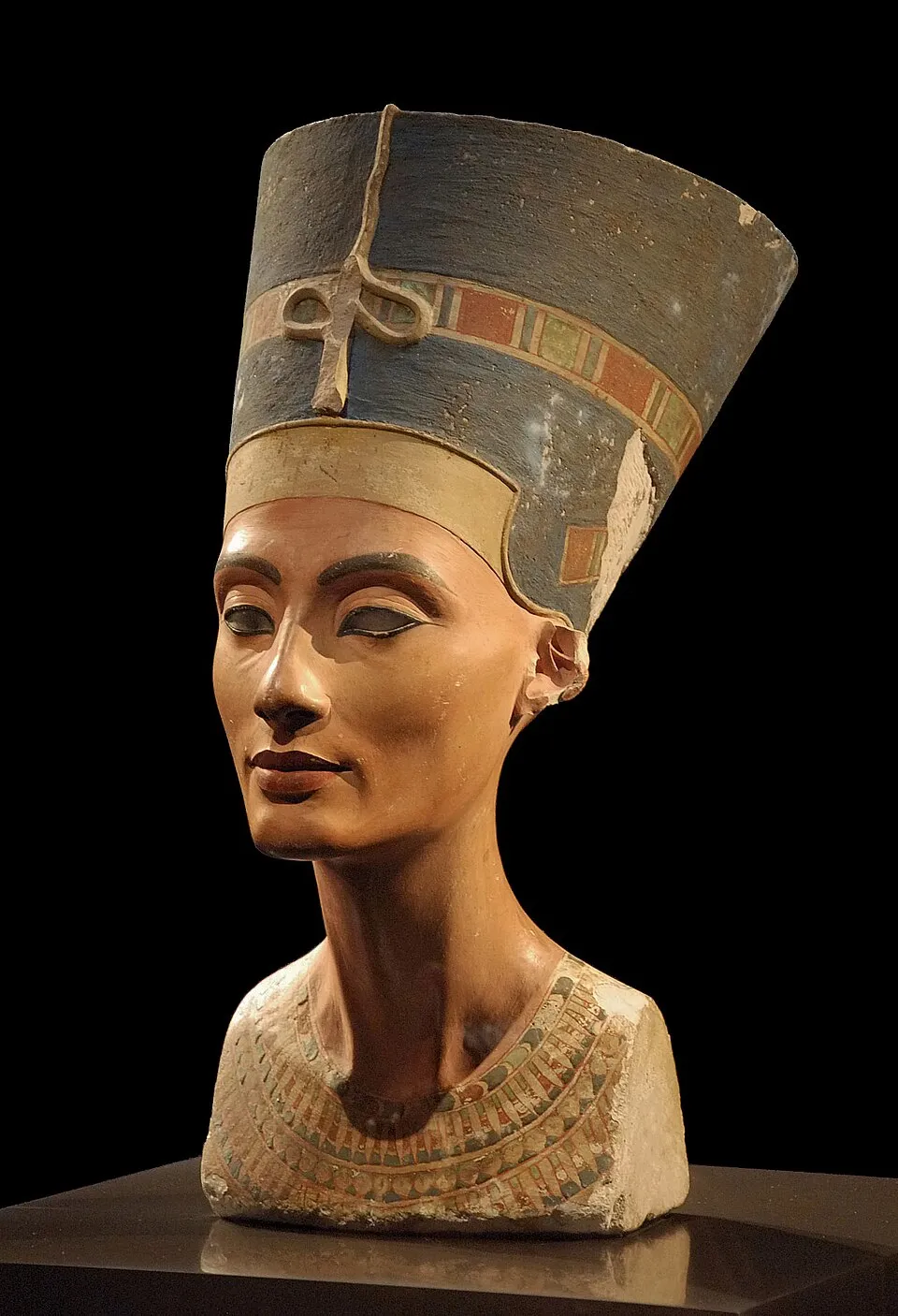 The Nefertiti Bust, c. 1345 BC, painted limestone, 48 cm tall, sculpted by Thutmose. Neues Museum, Berlin. Shows the queen with her distinctive blue crown and serene expression