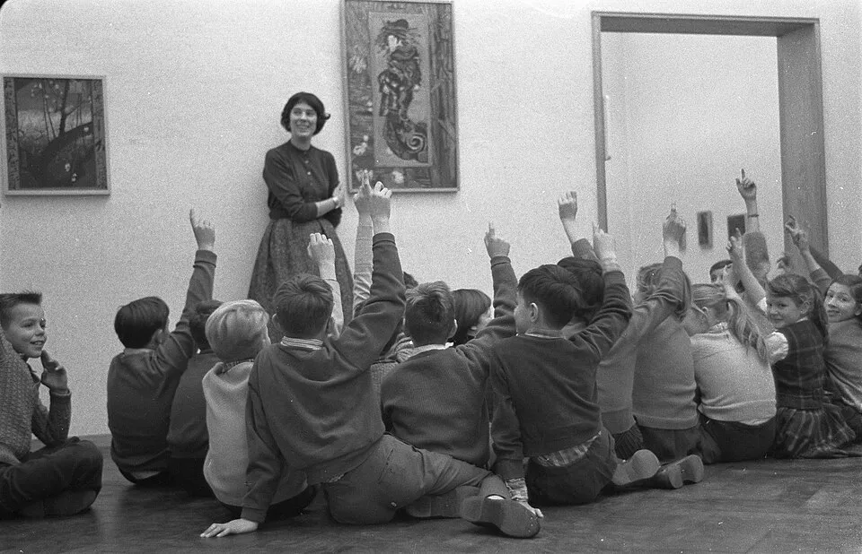 A group of teenagers standing in front of a painting in a museum, some engaged in discussion, others looking closely, demonstrating that art appreciation for teens works best when it connects to their own experiences and identity
