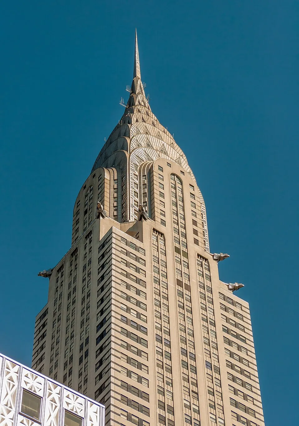 The Chrysler Building in New York City (1930) showing its distinctive stainless steel crown with sunburst arches and eagle gargoyles, one of the defining examples of Art Deco architecture