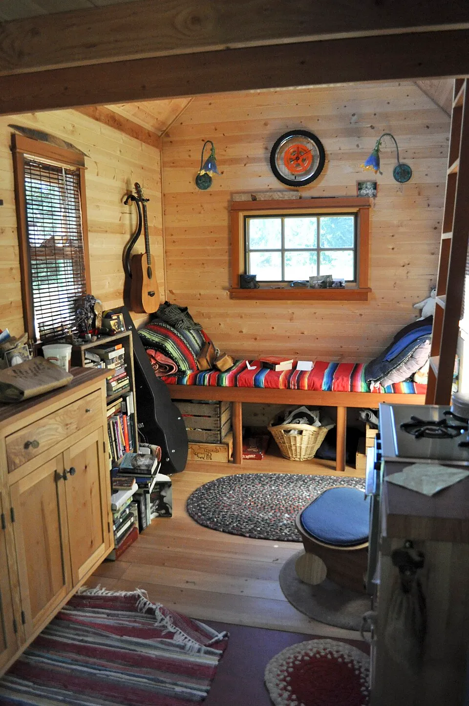 The interior of a tiny mobile house in Portland Oregon, demonstrating how even the smallest living spaces can incorporate art through intentional placement, scale, and framing choices