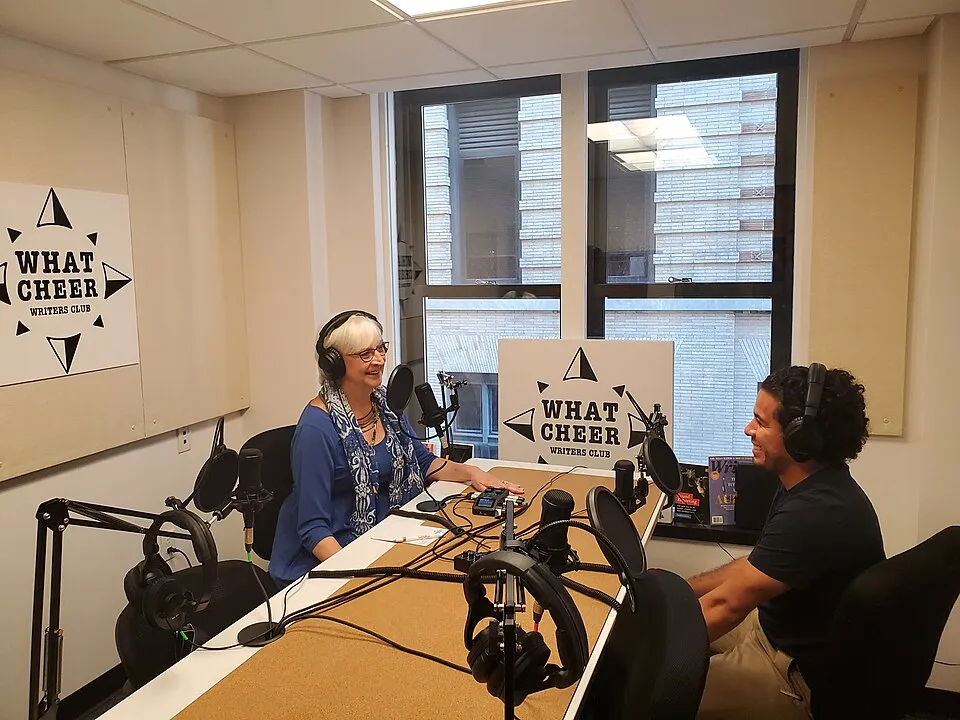 A podcast microphone and headphones on a desk, representing the medium that has become one of the most important platforms for art education and art world conversation
