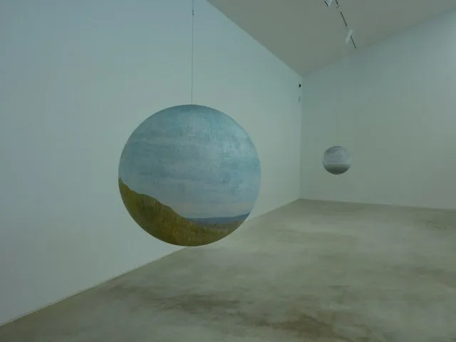 A contemporary art gallery interior with artworks on display, the world that Talk Art podcast hosts Russell Tovey and Robert Diament demystify for listeners