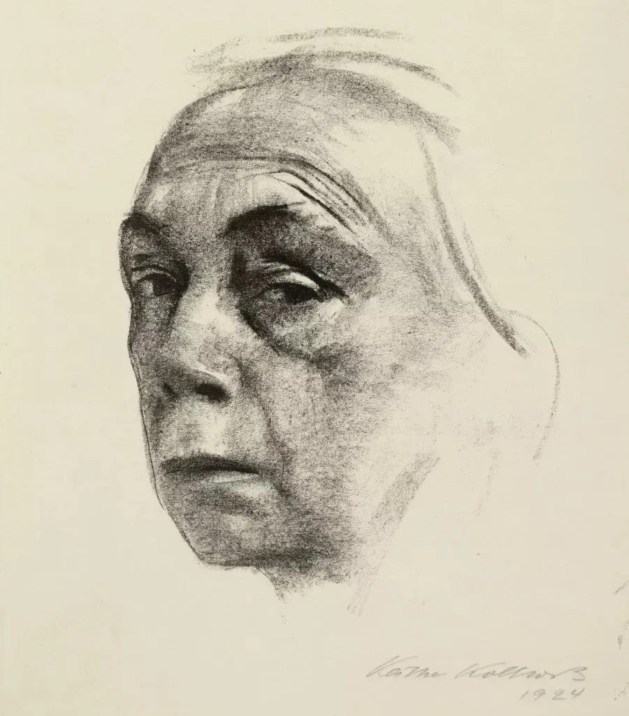 Self-Portrait (1924) by Kathe Kollwitz, a charcoal drawing showing the artist's face rendered in dark, deeply felt tonal values