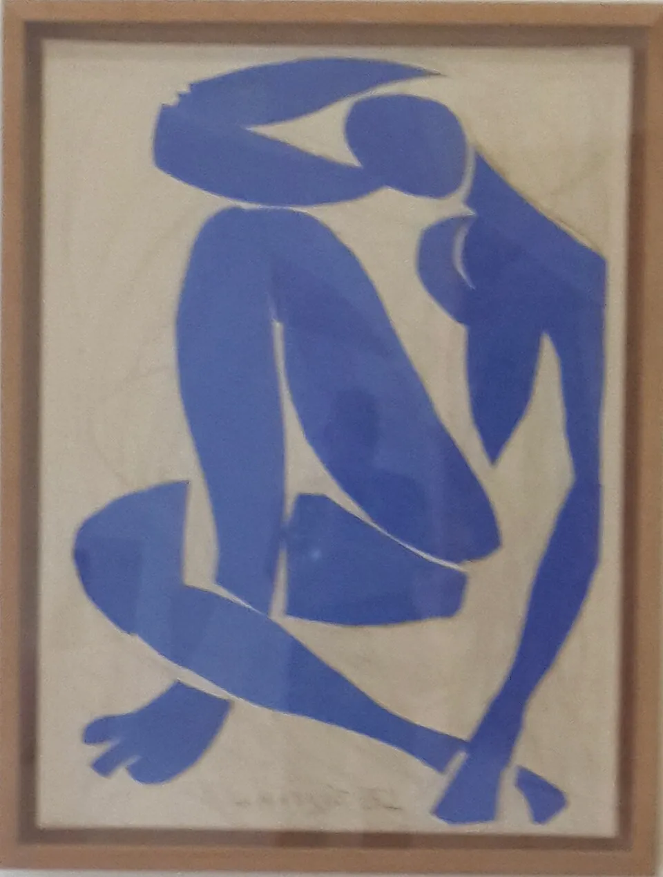 Henri Matisse, Blue Nude II (1952). A gouache-découpée cut-out of a blue female nude in a seated pose, made from painted paper cut with scissors and mounted on canvas, demonstrating Matisse's late-career technique developed after he became bedridden