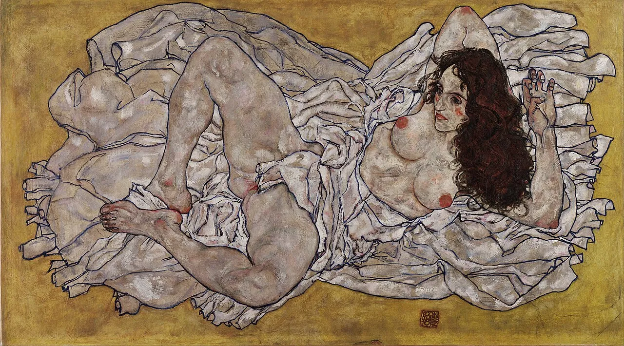 Reclining Woman with Green Stockings (1917) by Egon Schiele, a gouache and graphite figure drawing showing an angular, expressively distorted reclining female figure