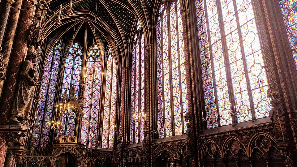 Sainte-Chapelle interior, Paris, showing 15 meters of stained glass on every side, deep blues and reds flooding the Gothic chapel