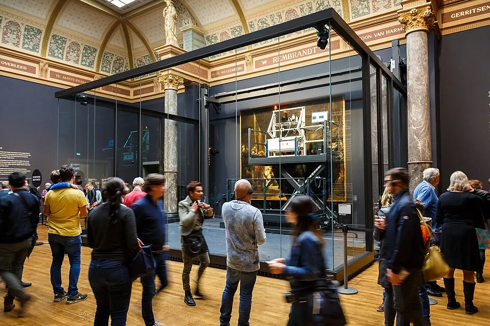 Rembrandt's The Night Watch during Operation Night Watch, examined with high-resolution digital photography, X-ray fluorescence analysis and spectroscopy in a glass enclosure, illustrating the kind of on-site inspection and scientific documentation that underpins a credible appraisal