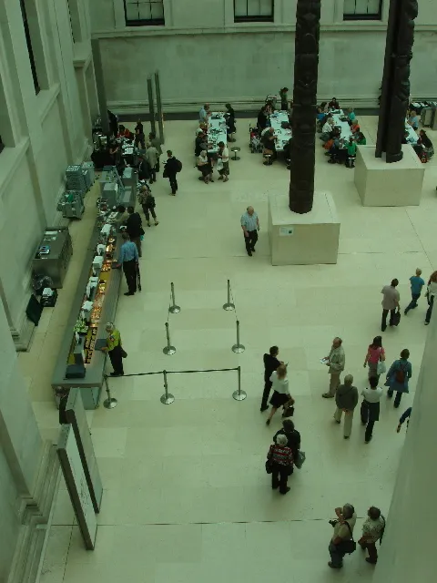 A person reading in an art gallery, the act of combining looking with reading, the foundation of following the art world without being overwhelmed