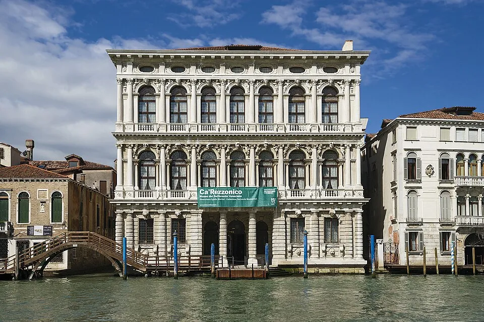A Venice canal with historic architecture, the city that hosts the Biennale, where the 31 collateral events are scattered across palazzos, churches, and alternative venues throughout Venice, making the Biennale not just an exhibition but a city-wide art event