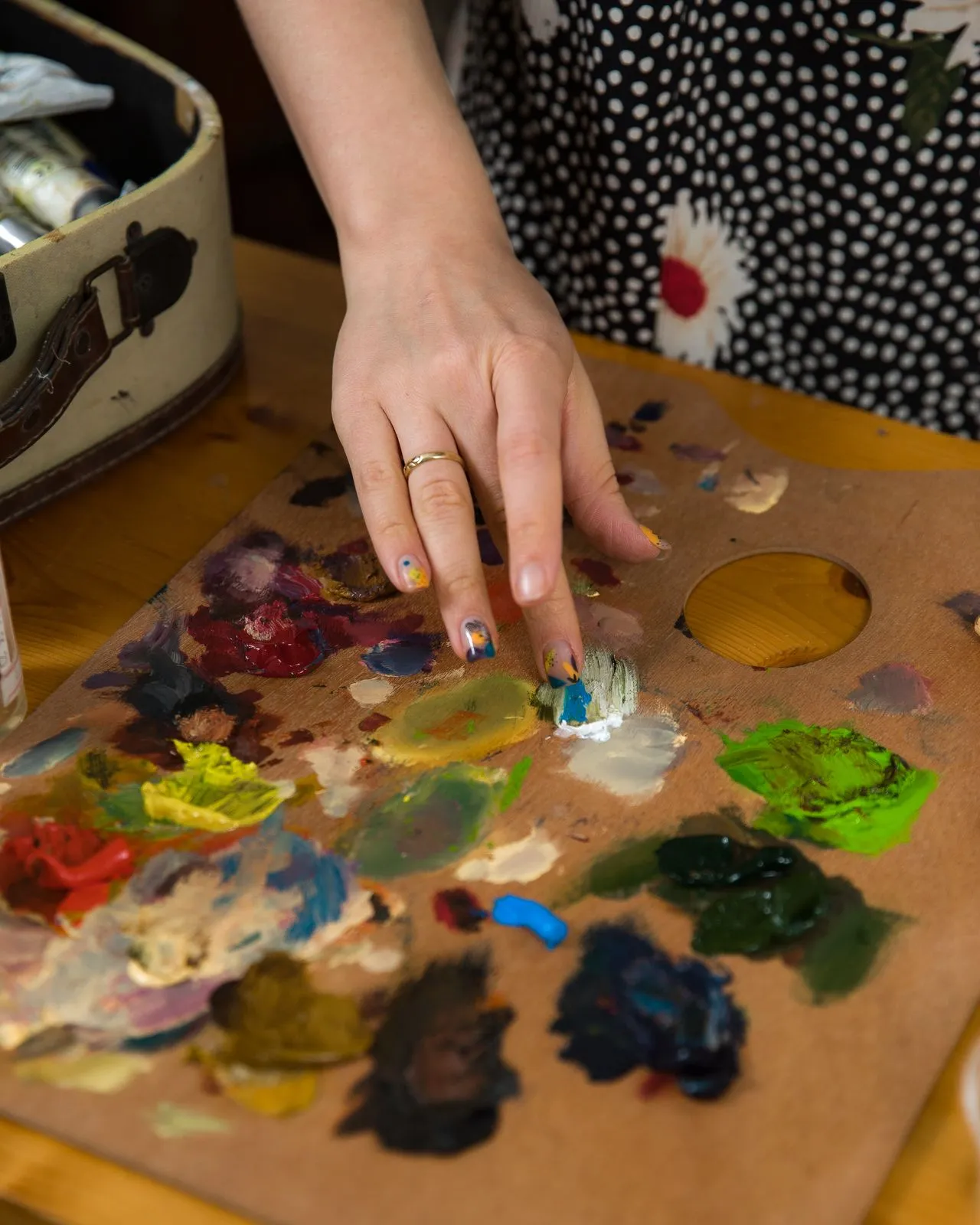 Artist working with limited materials at a studio bench, showing how constraints can focus creative decision-making