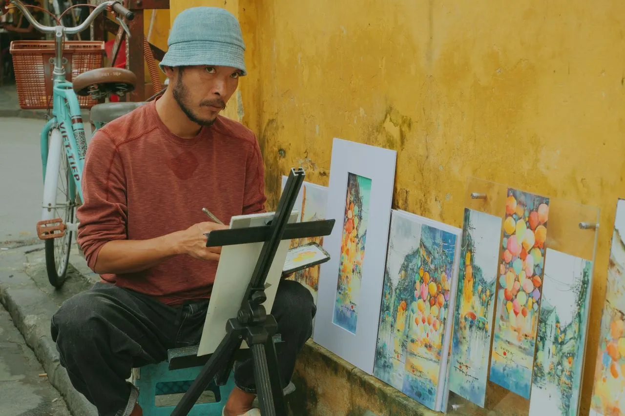 Artist stepping back from a canvas in a well-lit studio, evaluating their work with a critical eye