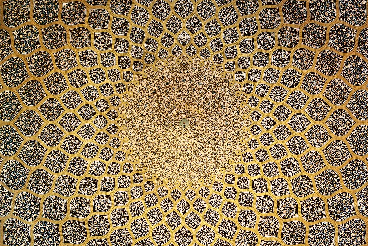 Interior dome of the Sheikh Lotfallah Mosque in Isfahan, Iran, showing the intricate geometric and arabesque tilework radiating from a central peacock motif, completed 1619