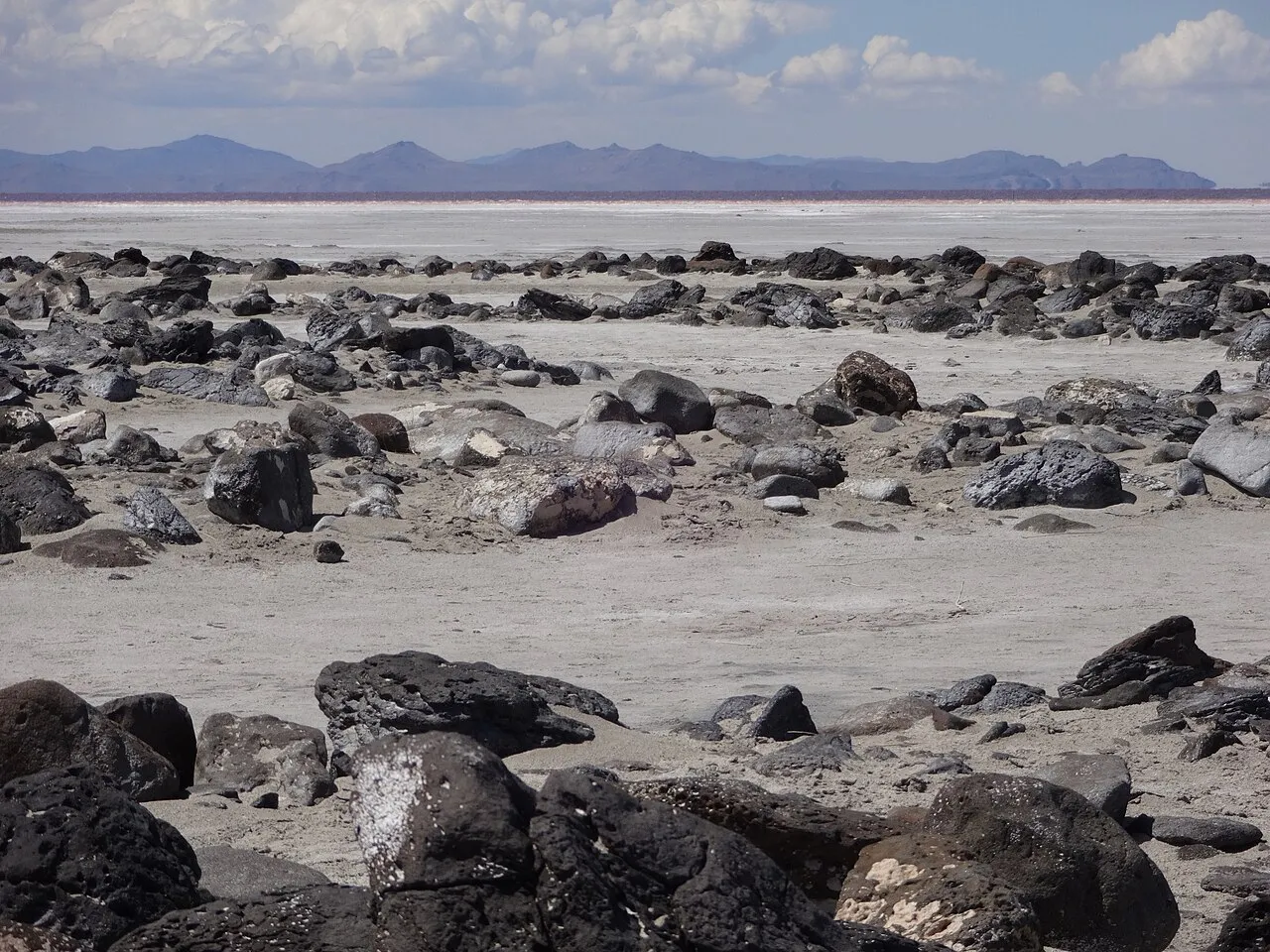 Robert Smithson's Spiral Jetty (1970) at Rozel Point, Great Salt Lake, Utah, showing the 1,500-foot spiral of black basalt rocks extending into the reddish salt lake waters, viewed from above
