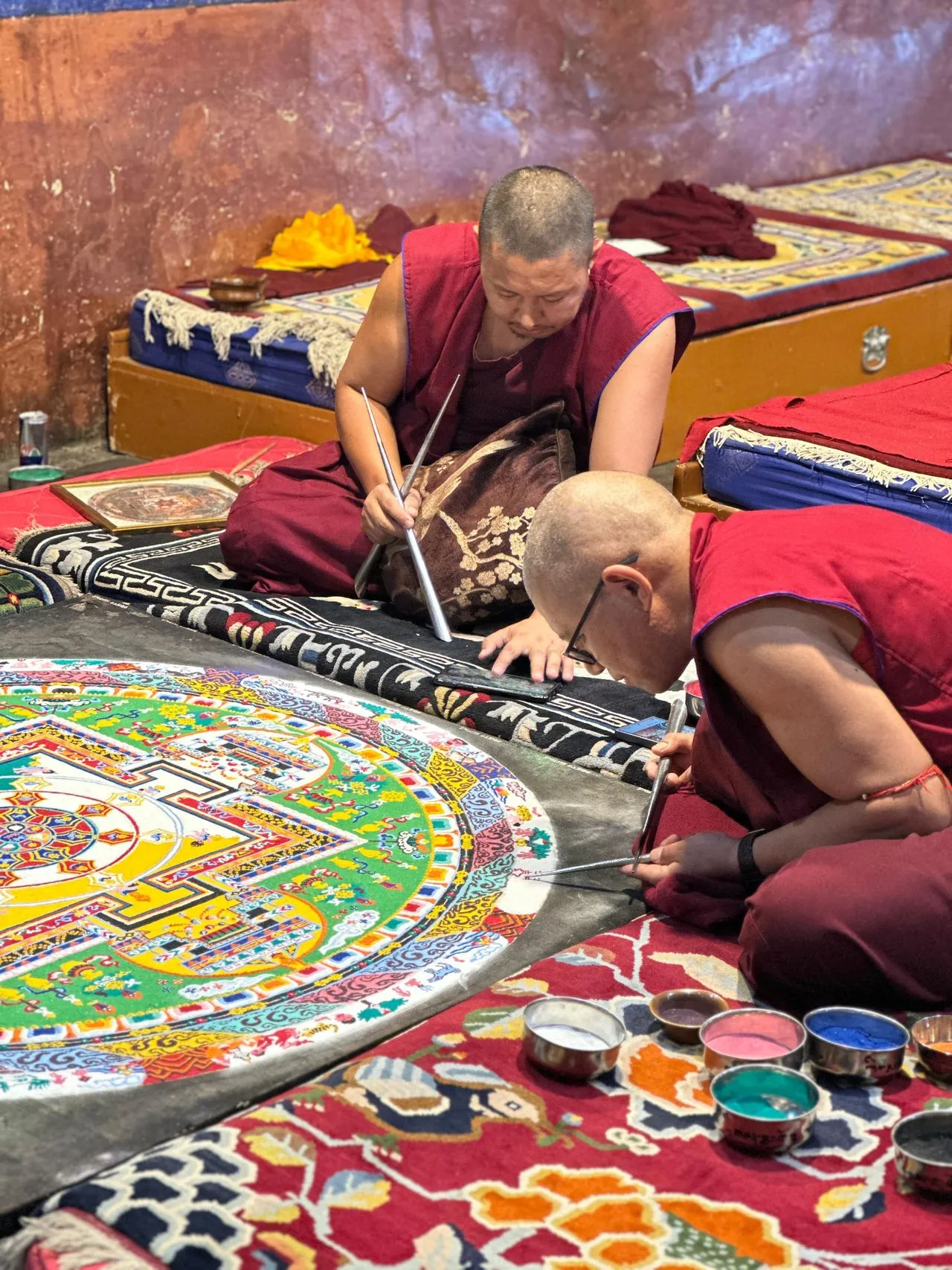 Colorful mandala pattern with concentric circles and geometric symmetry in detailed Buddhist-inspired design