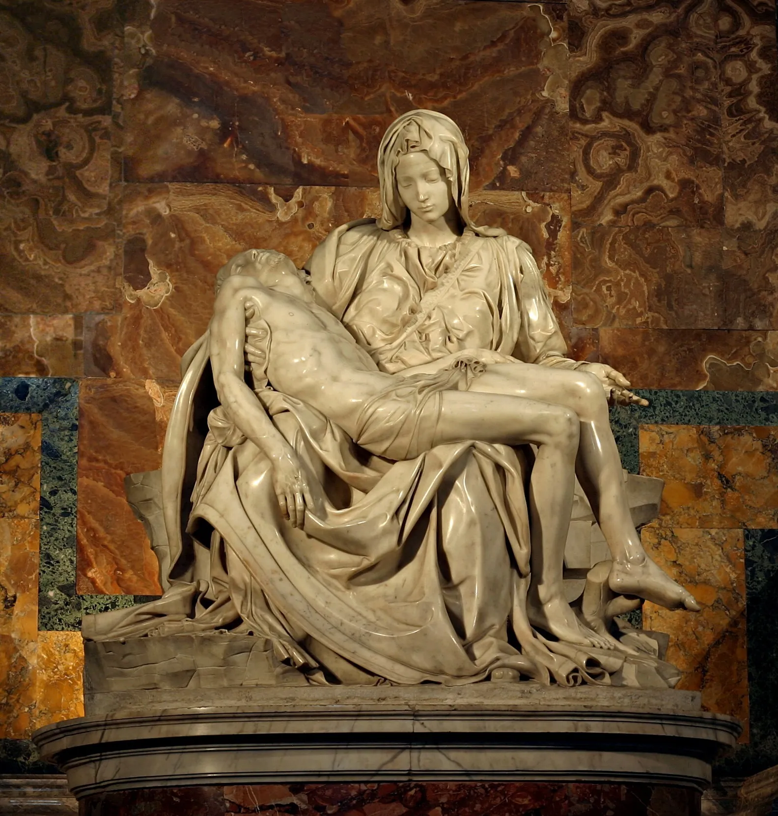Michelangelo's Pieta (1498-99) showing the Virgin Mary holding the body of Christ, carved in white marble with extraordinary surface polish and anatomical detail