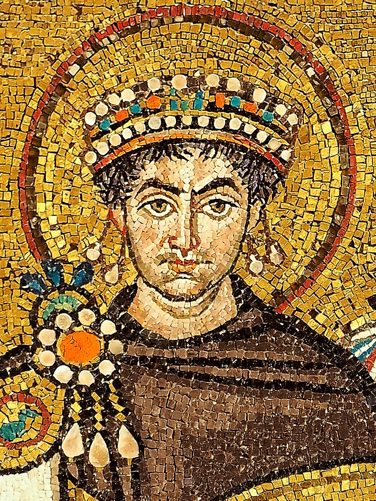 Mosaic of Emperor Justinian I from the Basilica of San Vitale, Ravenna (c. 547 CE), showing the emperor and his court in gold and jewel-toned glass tesserae against a gold background