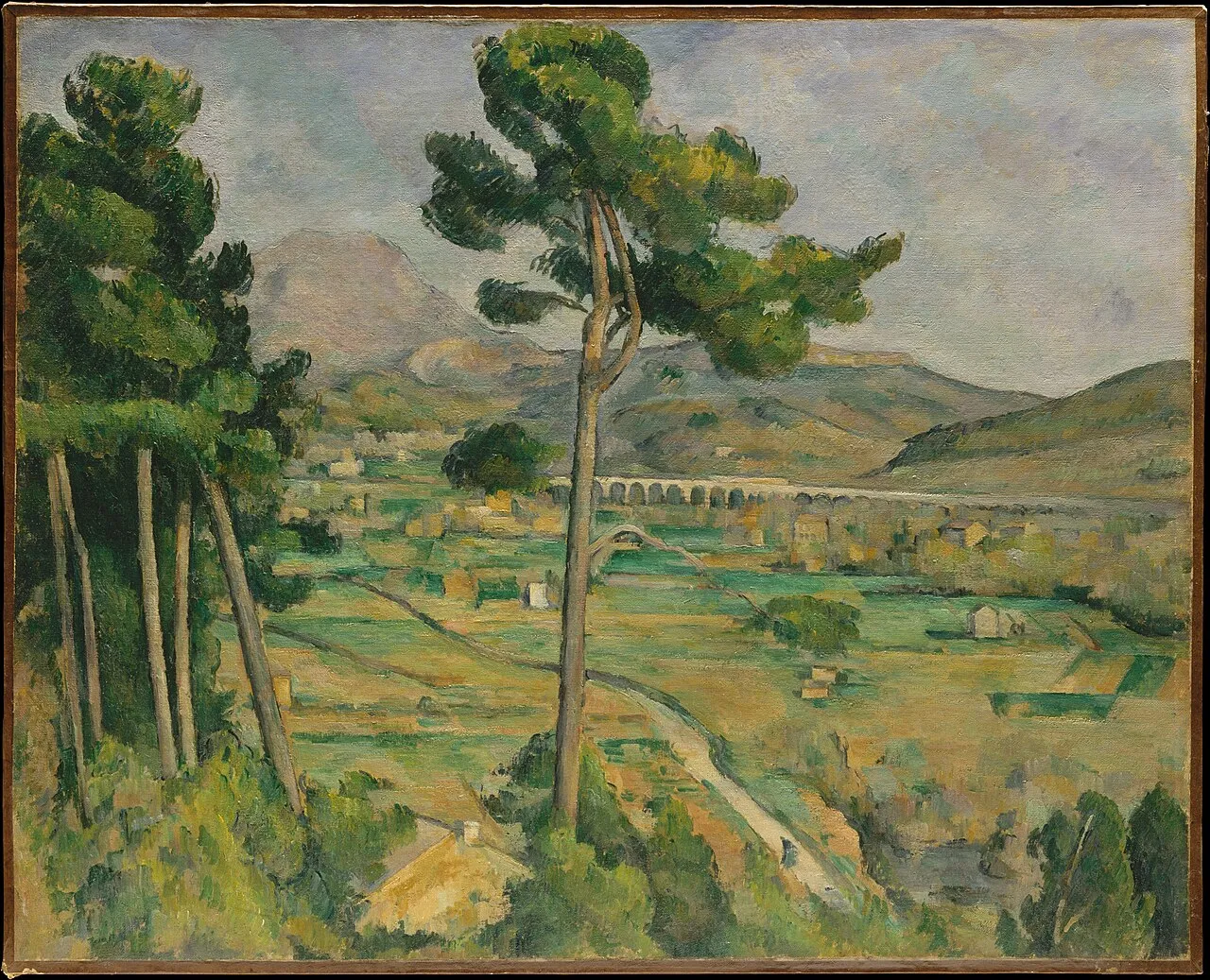 Mont Sainte-Victoire and the Viaduct of the Arc River Valley (1882-85) by Paul Cézanne showing the Provence landscape with the mountain, a viaduct in the middle ground, and pine trees framing the view, rendered in structured planes of color