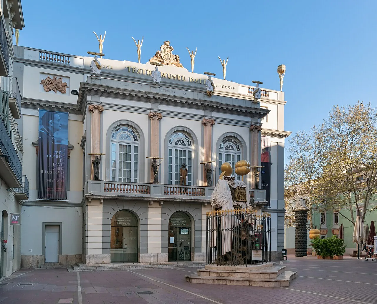 Exterior of the Dalí Theatre-Museum in Figueres, Spain, with its distinctive red walls and giant egg sculptures on the roof