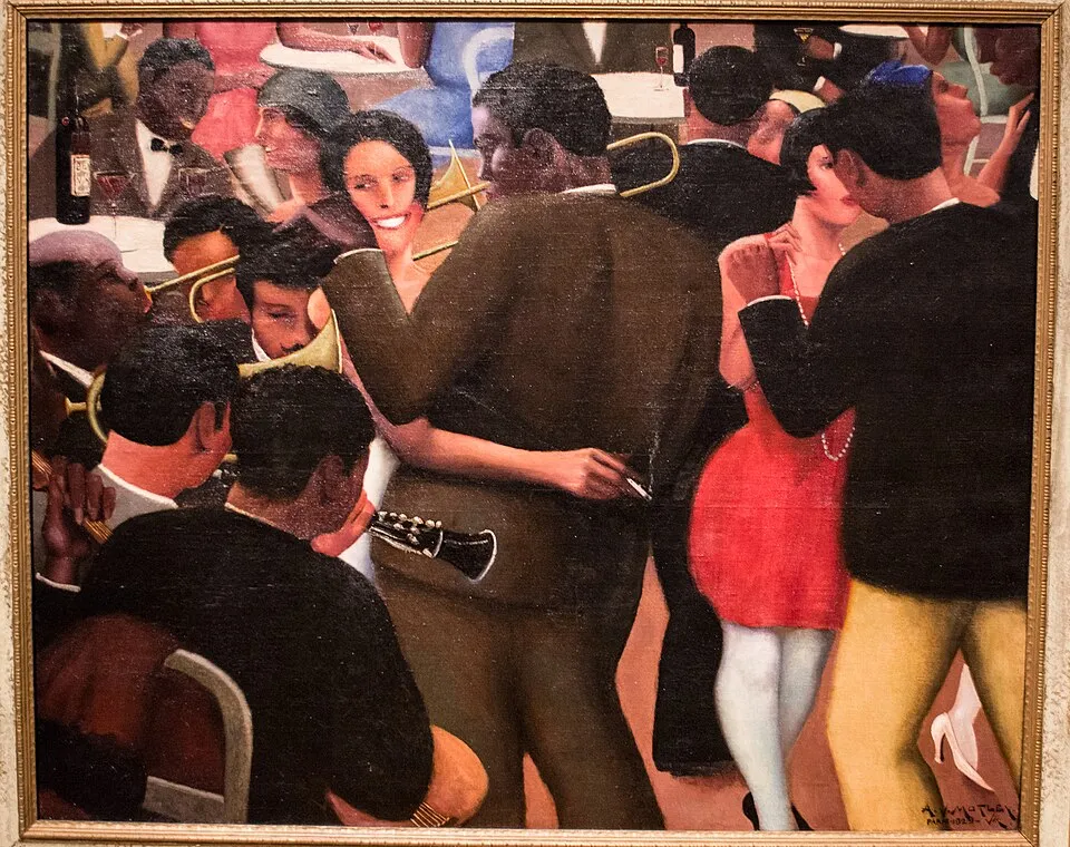 Archibald Motley, Blues (1929). A crowded nightclub scene with Black figures dancing and socializing in warm, saturated color.