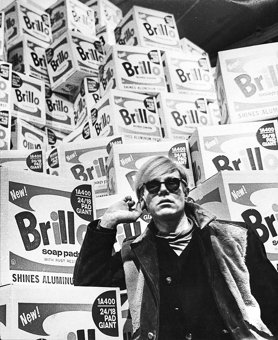 Andy Warhol, Brillo Boxes (1964). Wooden boxes silk-screened to look like Brillo soap-pad cartons, stacked in a gallery setting