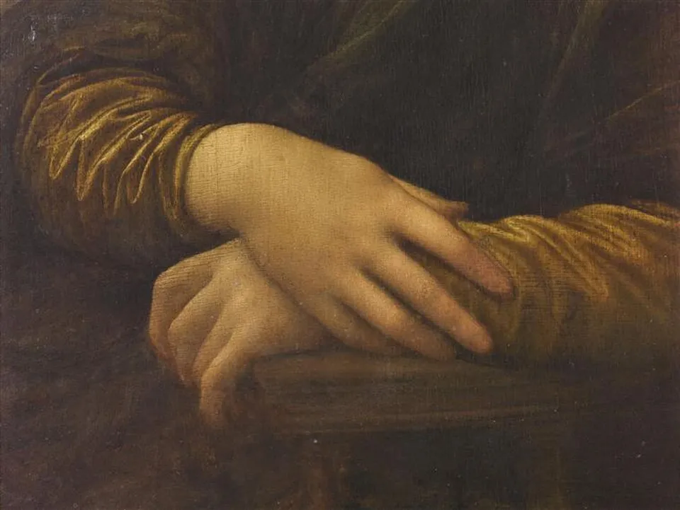 Detail of the Mona Lisa showing the folded hands of Lisa Gherardini, demonstrating Leonardo's sfumato technique and delicate rendering of skin and fabric