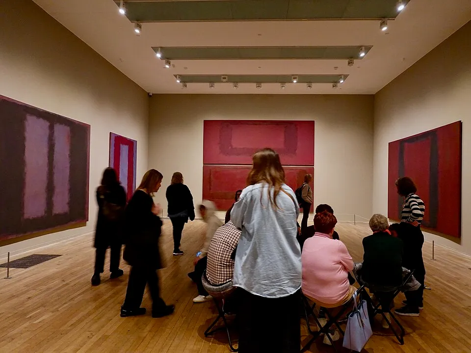 Mark Rothko, a large abstract painting with deep red and dark rectangular forms floating on a colored background.