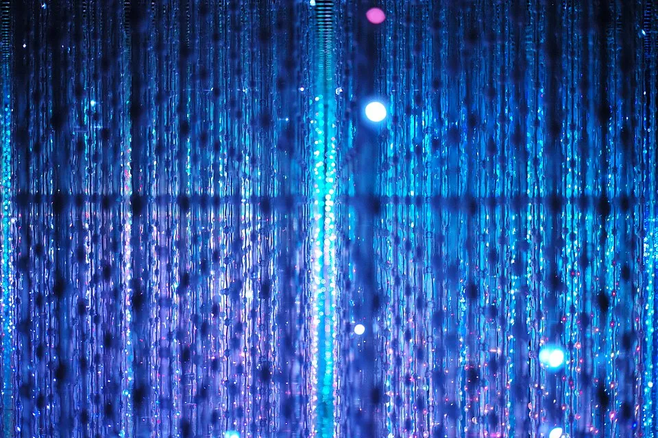 teamLab immersive light installation with visitors surrounded by flowing projected digital imagery responding to their movements
