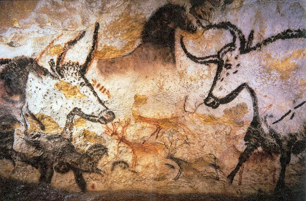 Prehistoric cave paintings at Lascaux showing large animal figures rendered in mineral pigments on rock walls