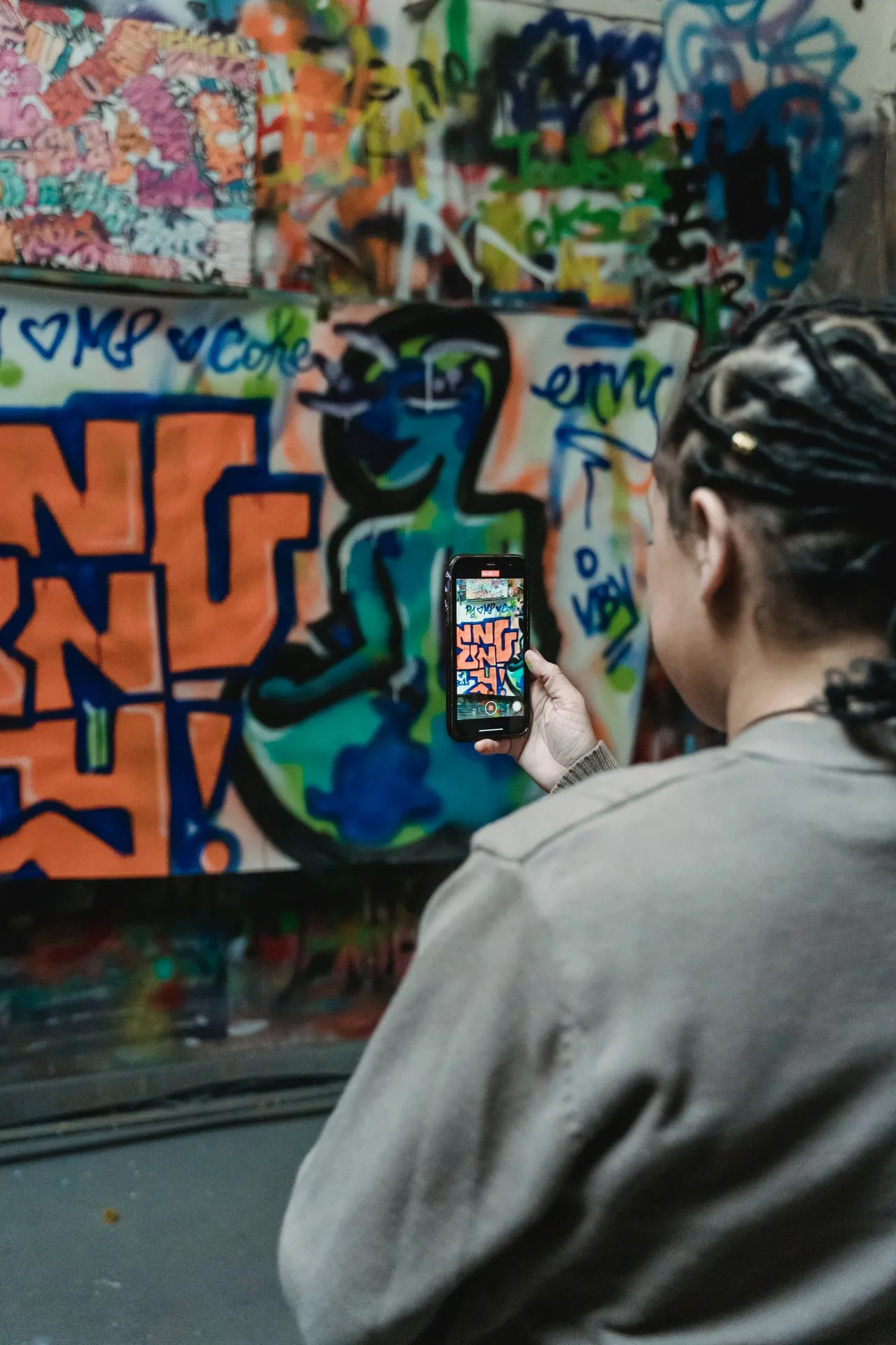 Street art and graffiti on an urban wall with layered paint and stencil work
