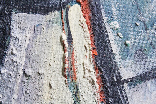 A close-up macro shot of an oil painting showing the ridges of the paint (Impasto)