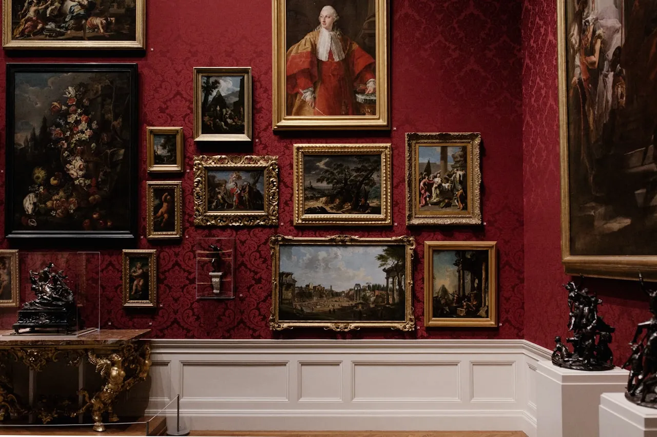 A sunlit art gallery interior with visitors contemplating paintings on white walls